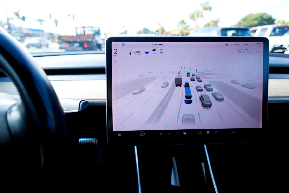 A Tesla Model 3 vehicle drives using FSD (Full Self-Driving) in Encinitas, Calif., on Oct. 18, 2023.     (Mike Blake/Reuters)