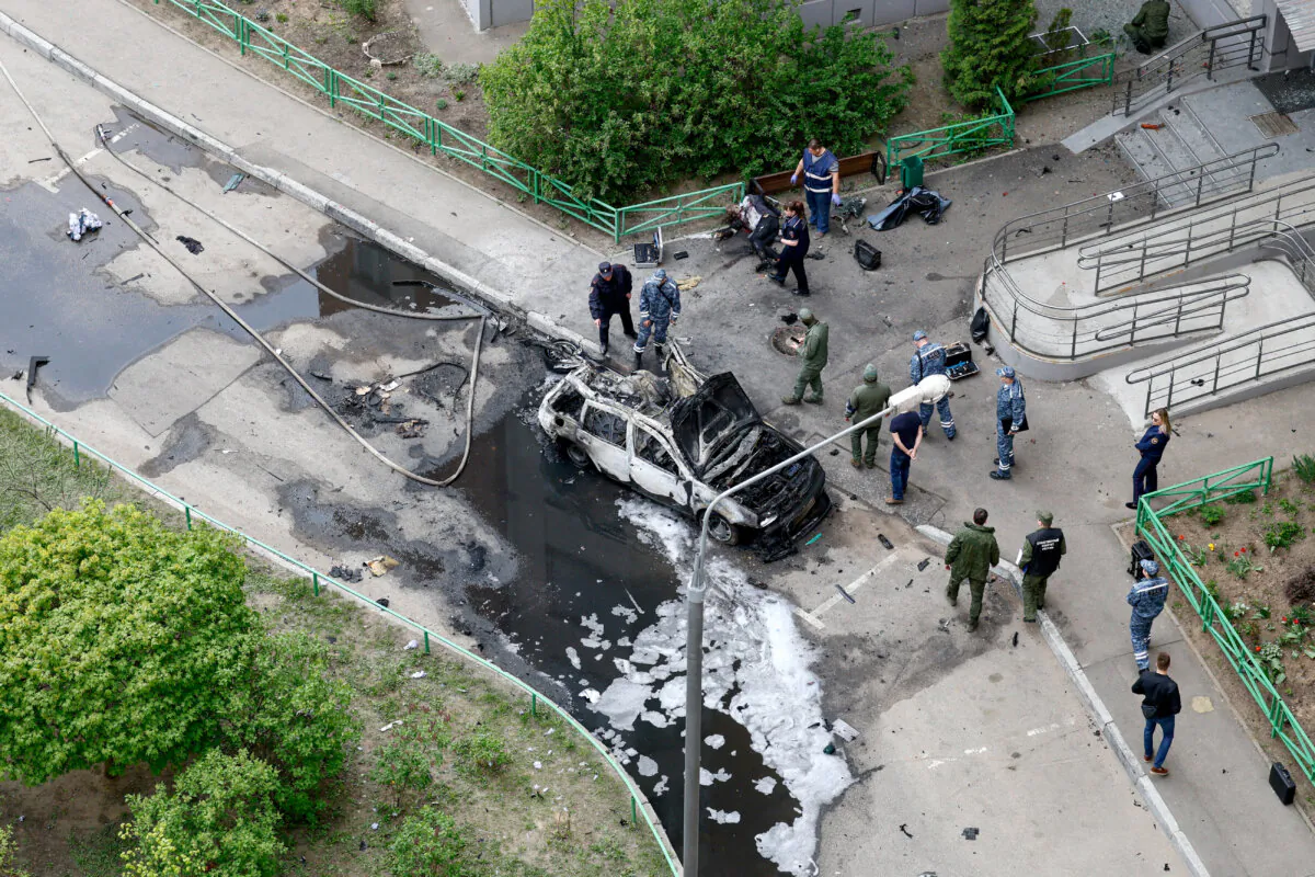 Law enforcement officers work at the site of a car bomb, which killed senior Russian military officer, in Balashikha, outside Moscow, Russia, on April 25, 2025. (Yulia Morozova/Reuters)