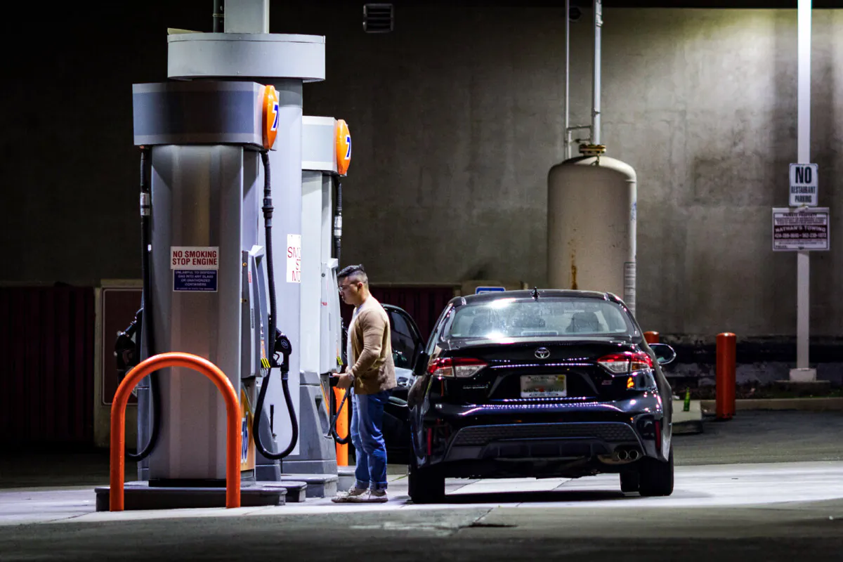 A customers fuels his vehicle at a gas station in Los Angeles on March 25, 2025. (John Fredricks/The Epoch Times)