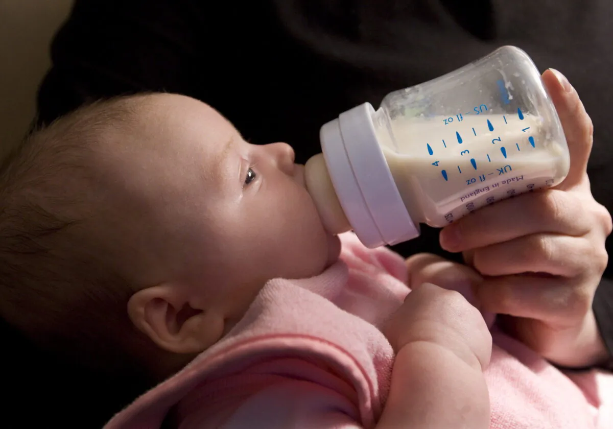 A 6-week-old baby girl drinks from a nursing bottle in North Vancouver, in a file photo. (The Canadian Press/Jonathan Hayward)