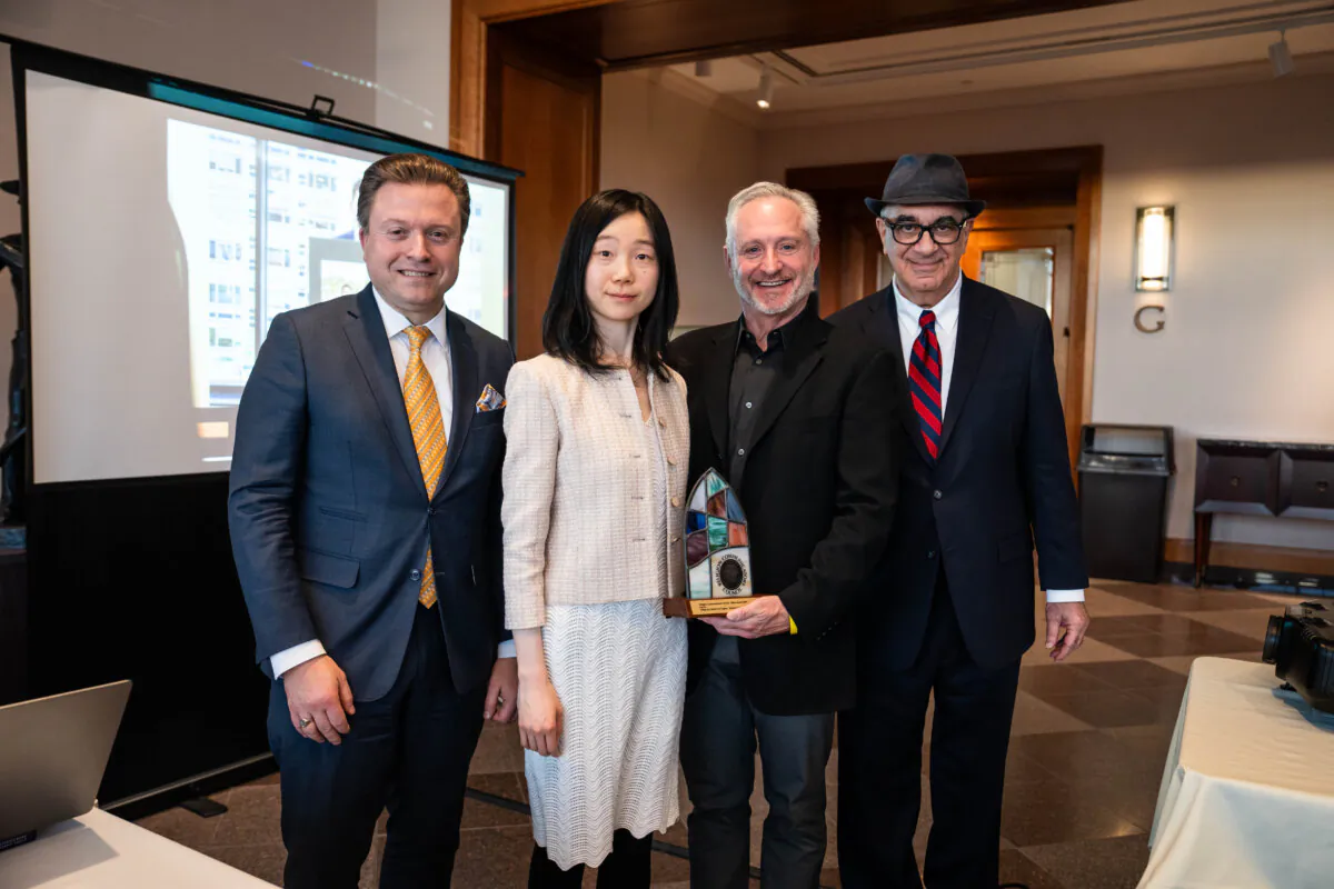 Epoch Times senior editor Jan Jekielek (L) and reporters Eva Fu (2nd L) and Dan Berger (R) pose with Brad Pomerance (2nd R), awards coordinator for the Religion Communicators Council, at the organization's 2025 Wilbur Awards banquet in Salt Lake City on April 25, 2025. (Madalina Vasiliu/The Epoch Times)