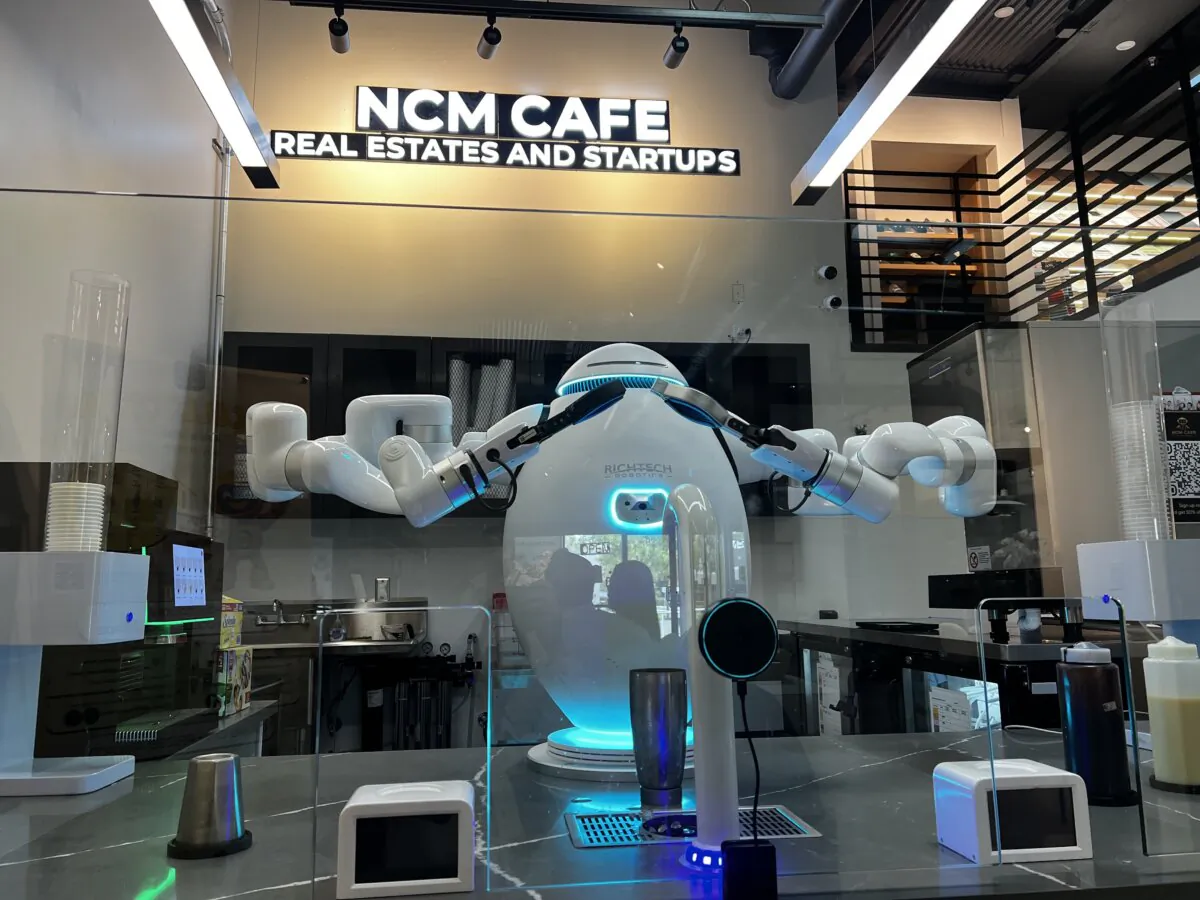 AI-powered robot barista _C_ prepares to make drinks at NCM Cafe in San Jose, Calif., on April 25, 2025. (Conner Lee/The Epoch Times)