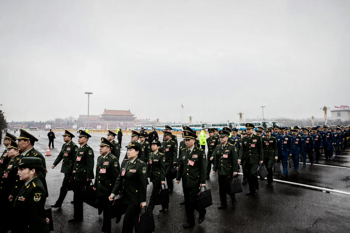 Military delegates arrive for the opening session of the National People’s Congress at the Great Hall of the People in Beijing on March 5, 2024. China’s annual Two Sessions gathering brings together leaders and lawmakers to set the regime's agenda for economic and social development. (Lintao Zhang/Getty Images)