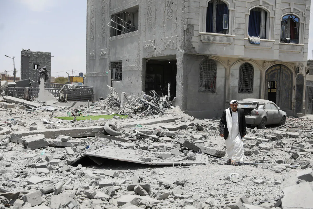 A man walks across the rubble of a building destroyed by a U.S. airstrikes in Sanaa, Yemen on April 27, 2025. (Khaled Abdullah/Reuters)