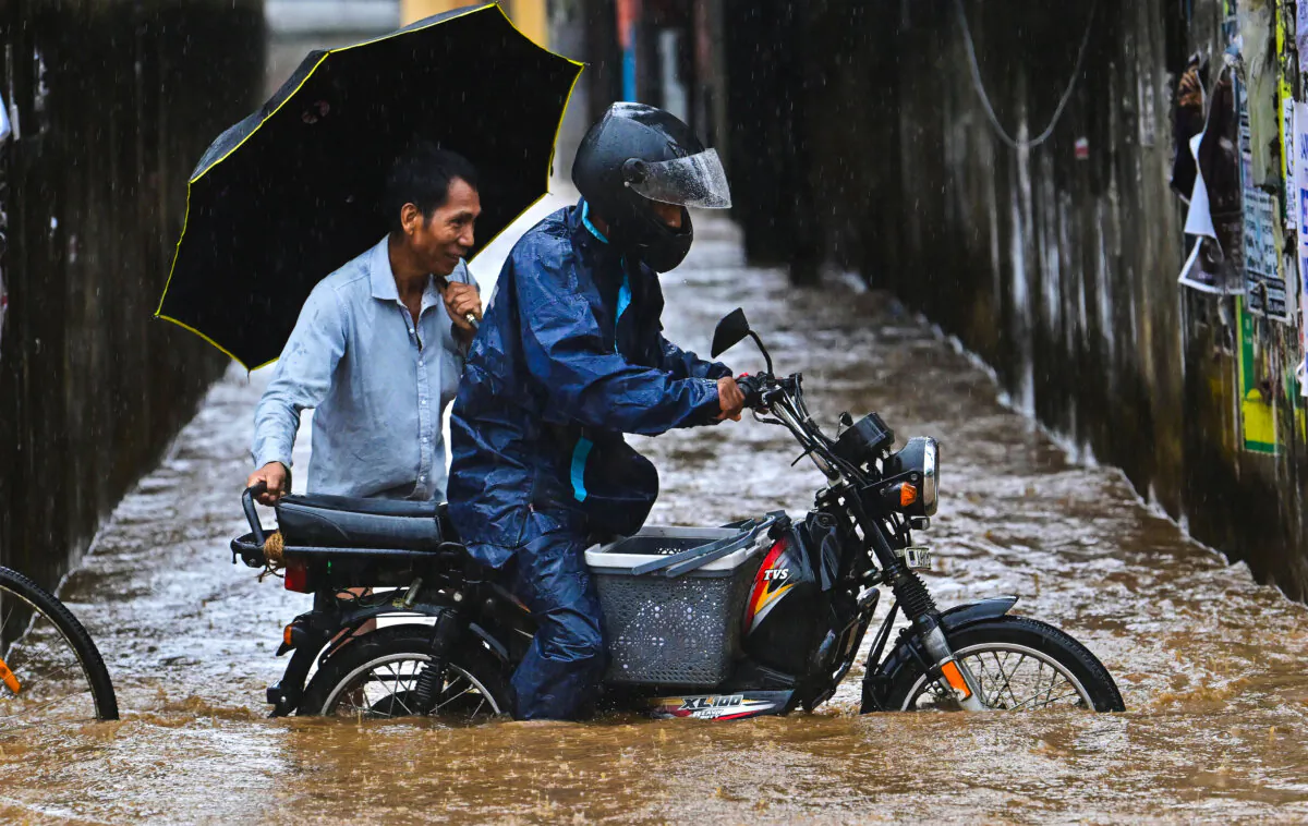 A moped pushes through a flooded street after heavy rainfall in Guwahati, India, on April 28, 2025. (Biju Boro/AFP via Getty Images)