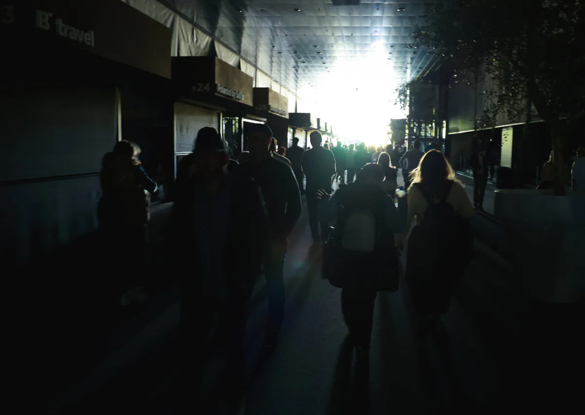 Fans walk through the dark gangways during a general power blackout during Day Seven of the Mutua Madrid Open at La Caja Magica, in Madrid, Spain, on April 28, 2025. A widespread power outage hit Spain, Portugal, and parts of France. (Clive Brunskill/Getty Images)