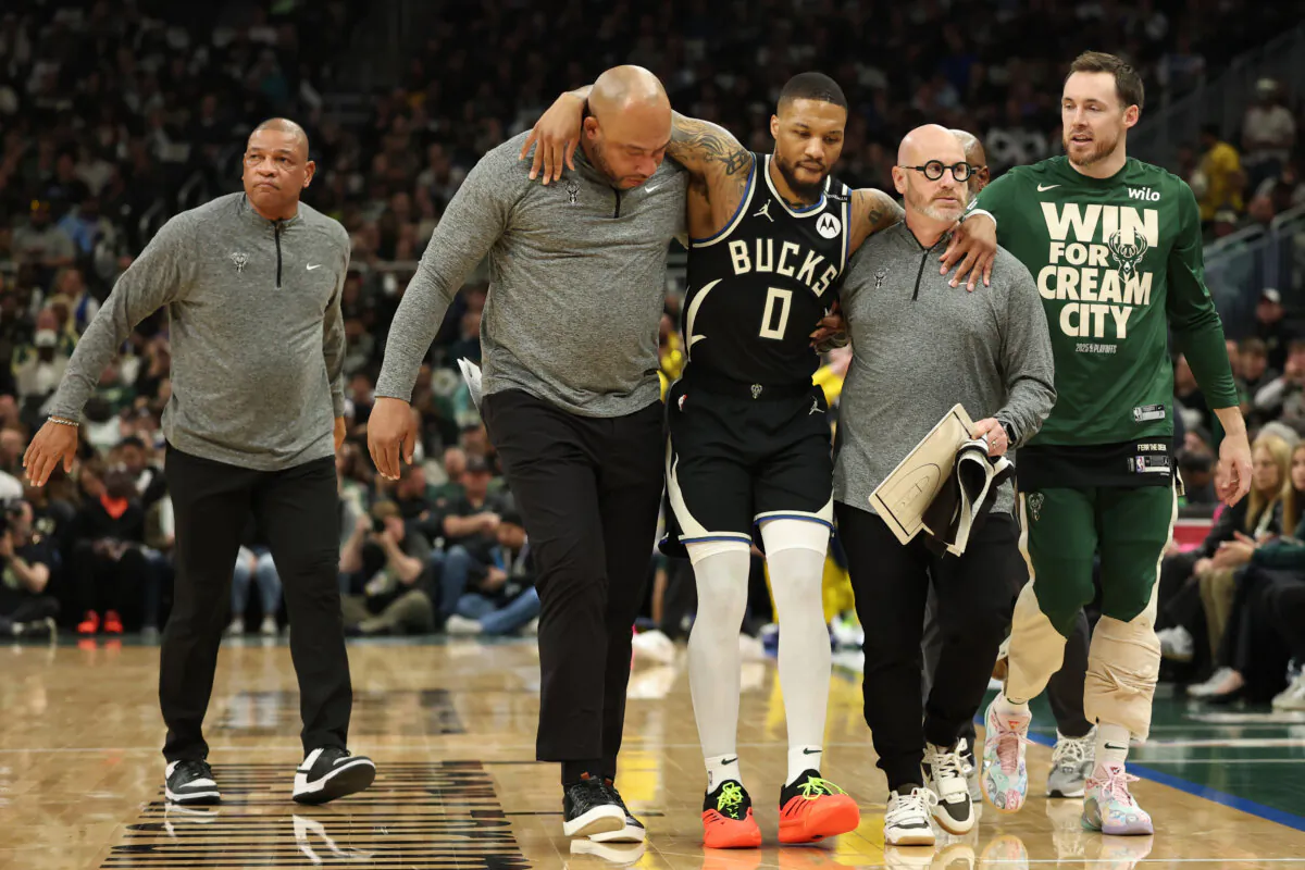 Damian Lillard #0 of the Milwaukee Bucks is helped off the court after an apparent injury during the first quarter in Game Four of the Eastern Conference First Round NBA Playoffs against the Indiana Pacers at Fiserv Forum in Milwaukee, Wis., on April 27, 2025. (Stacy Revere/Getty Images)