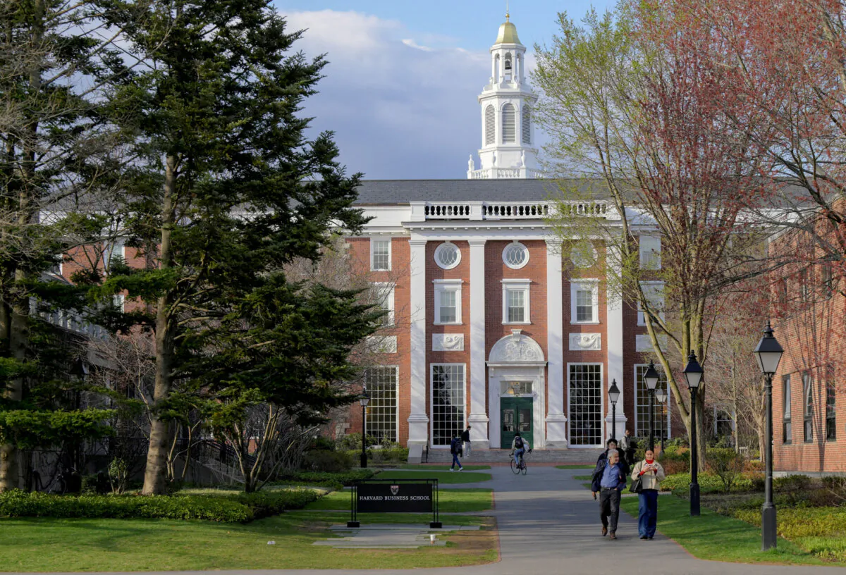 People walk on the Business School campus of Harvard University in Cambridge, Mass., on April 15, 2025. (Faith Ninivaggi/Reuters)