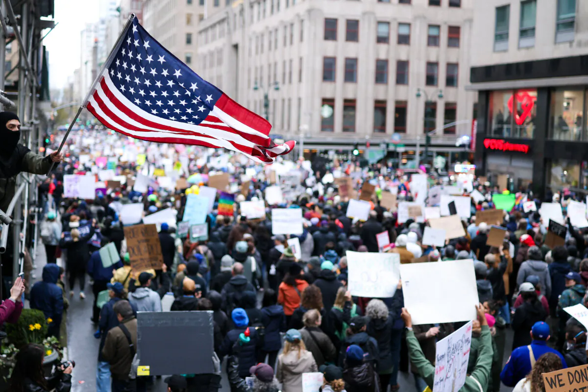 Demonstrators march during the nationwide “Hands Off!” protest against President Donald Trump and his advisor, Tesla CEO Elon Musk, in New York on April 5, 2025. (Charly Triballeau/AFP via Getty Images)