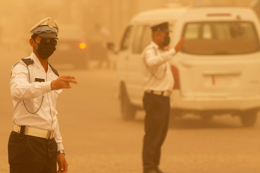 Day in Photos: Sand Storm in Iraq, Memorial Day for Fallen Soldiers, and Nazi Concentration Camp