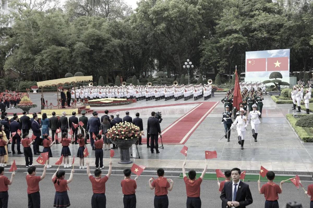 Vietnamese General Secretary of the Communist Party To Lam and Chinese leader Xi Jinping review the guard of honor during a ceremonial welcome at the Presidential Palace in Hanoi on April 14, 2025. (Luong Thai Linh/Pool/AFP via Getty Images)