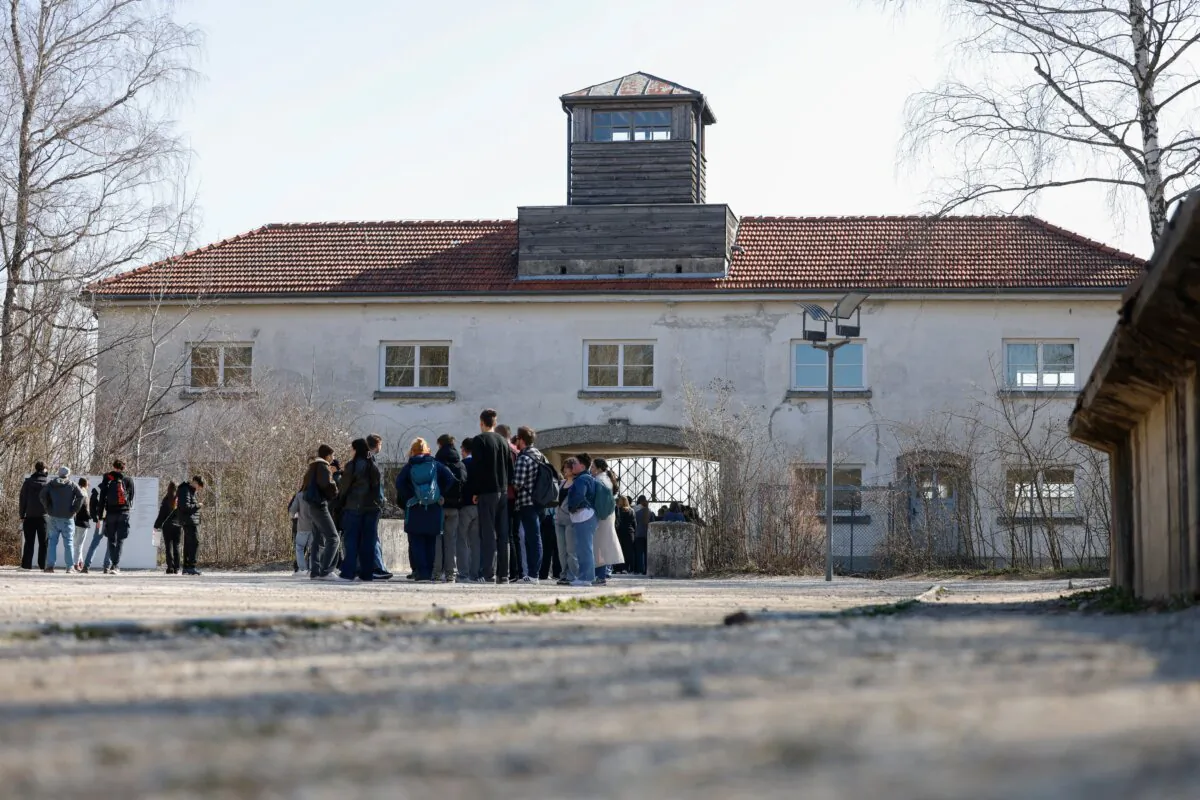 Visitors stand in front of the Jourhaus, the entrance building to the prisoners' camp at the former Dachau concentration camp near Munich on April 3, 2025. (Michaela Stache/AFP via Getty Images)