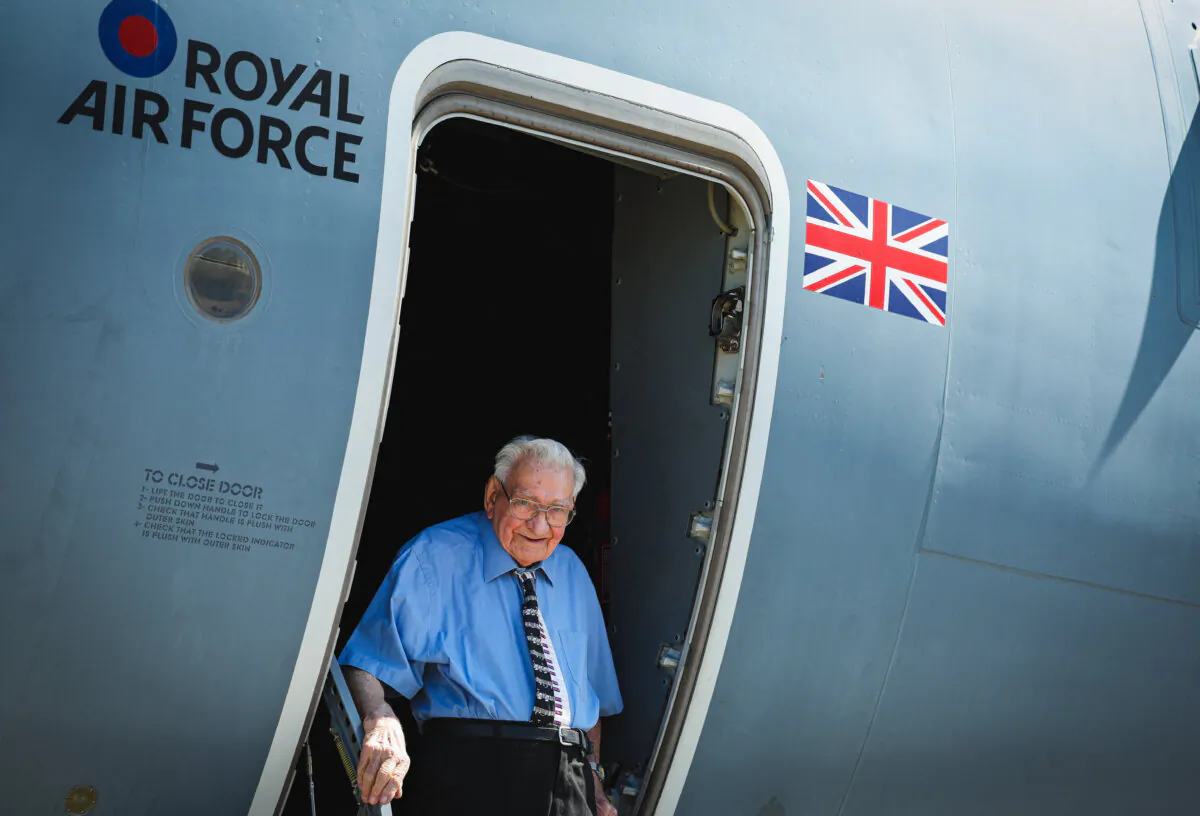 99-year-old Royal Air Force veteran Dennis Bishop poses for a photograph in the door of an Airbus A400M Atlas aircraft, during a VE Day 80 media event at RAF Brize Norton, in Oxfordshire, UK, on April 30, 2025. Bishop served during World War II as a ground radio operator and landed at Normandy after the main landings. He also served in Africa and Europe during the war. (Adrian Dennis/AFP via Getty Images)