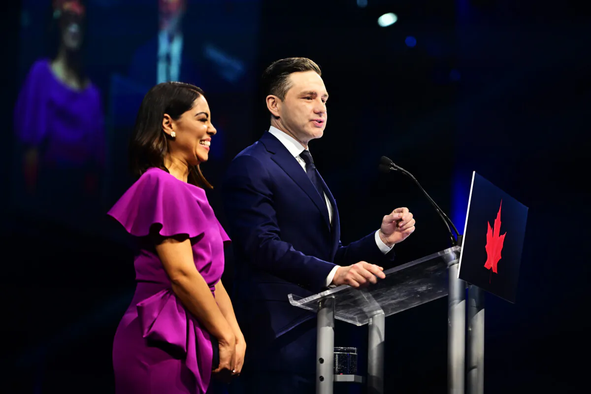 Conservative Leader Pierre Poilievre speaks to supporters with his wife Anaida Poilievre at his campaign headquarters on election night in Ottawa on April 29, 2025. (The Canadian Press/Spencer Colby) 