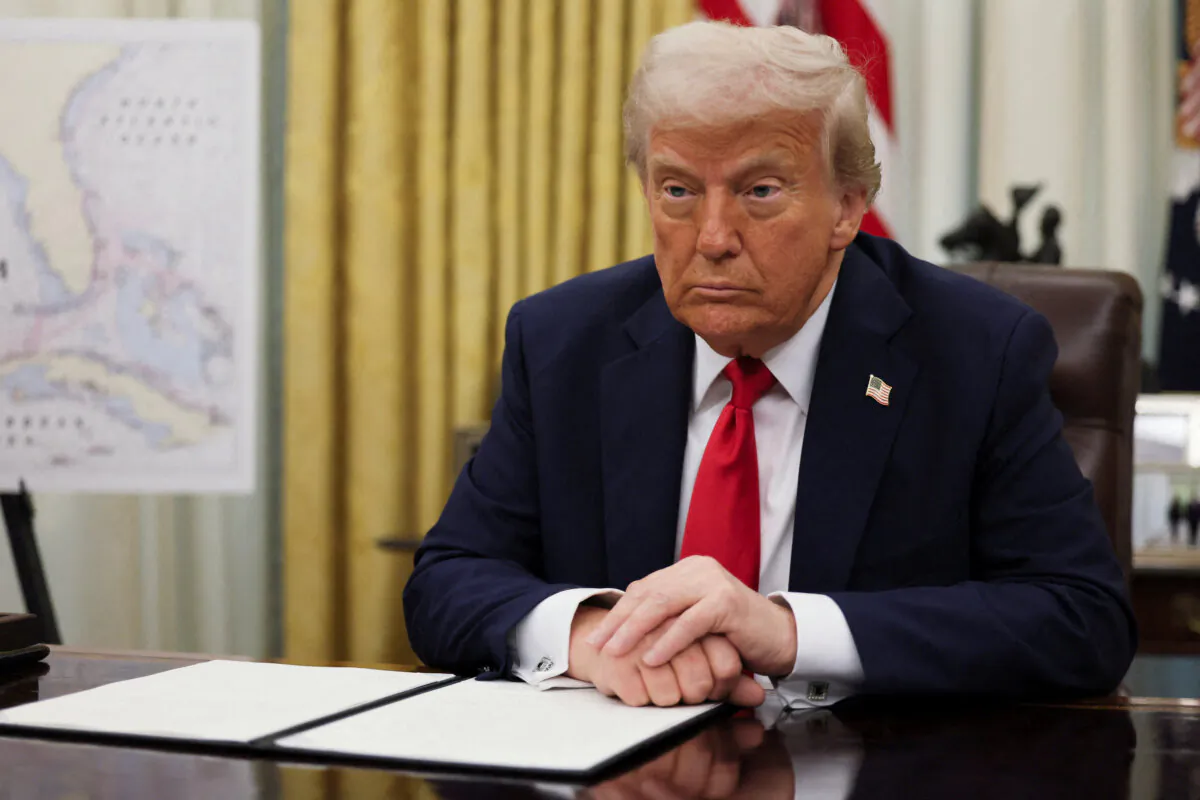 President Donald Trump prepares to sign an executive order in the Oval Office at the White House on March 31, 2025.   (Leah Millis/Reuters)