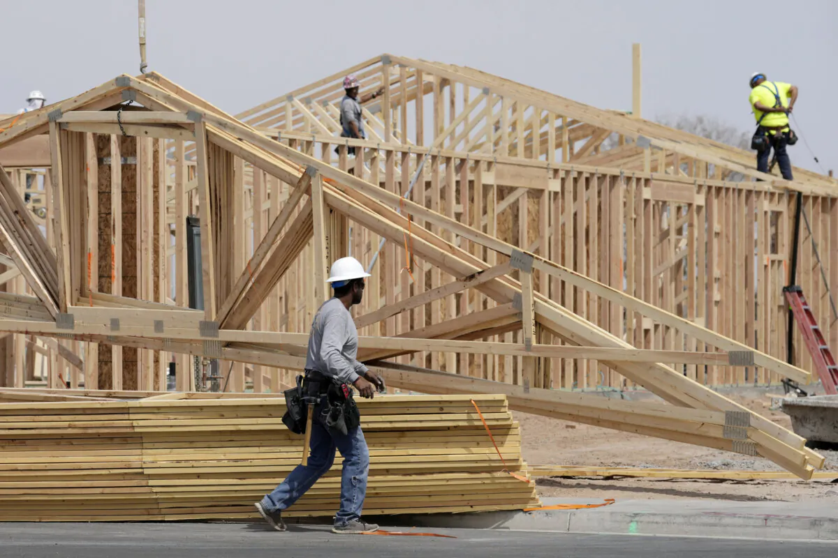 Construction workers install a roof at a new home build in Laveen, Ariz., on April 1, 2025. (Ross D. Franklin/AP Photo)