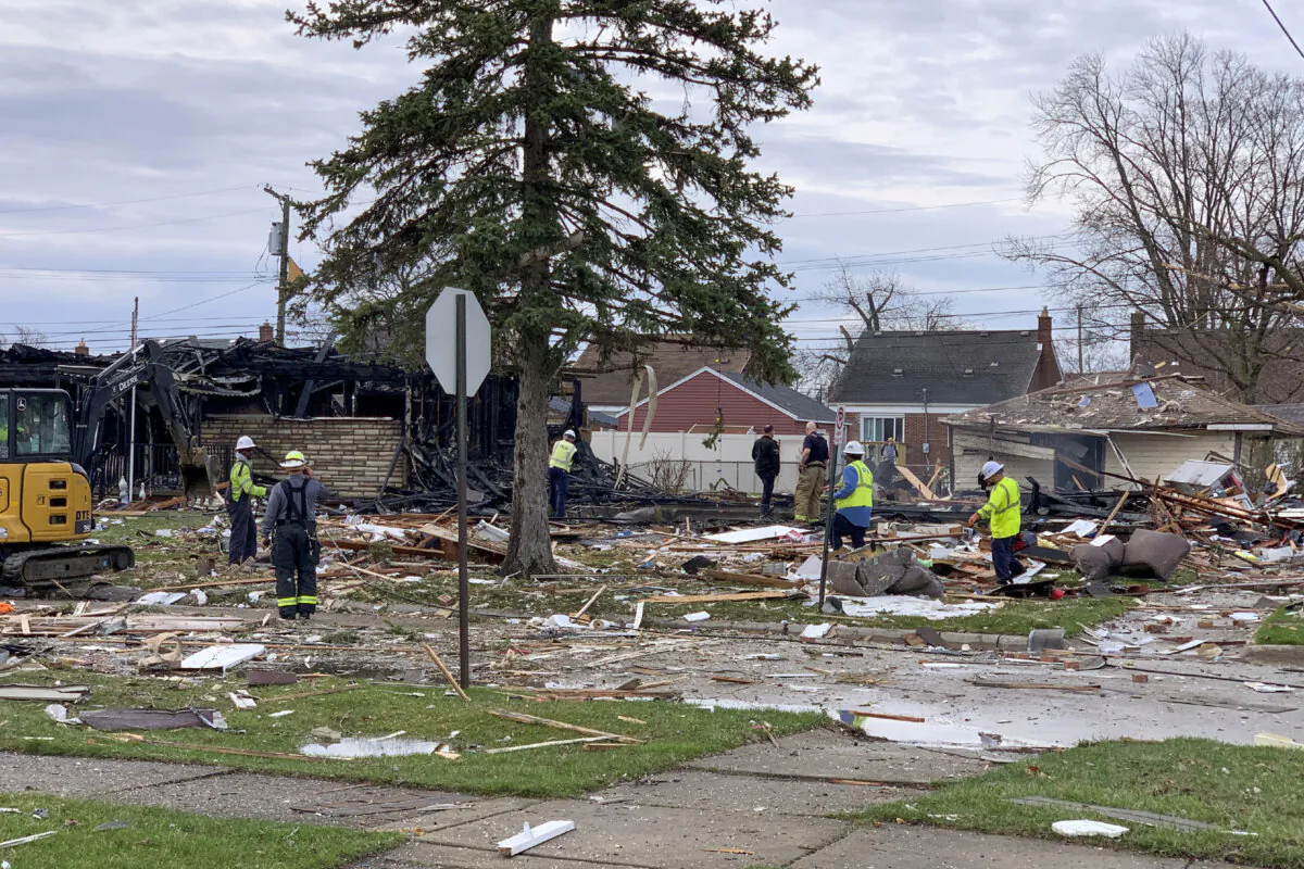 Rescue workers search over the scene of a home explosion in Southgate, Mich., on April 3, 2025. (Charles E. Ramirez/Detroit News via AP)
