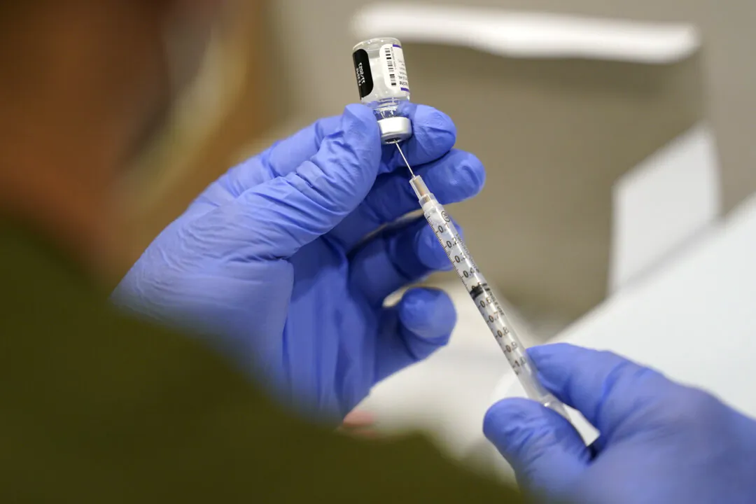 A healthcare worker fills a syringe with the Pfizer COVID-19 vaccine at Jackson Memorial Hospital on Oct. 5, 2021, in Miami. (AP Photo/Lynne Sladky, File)