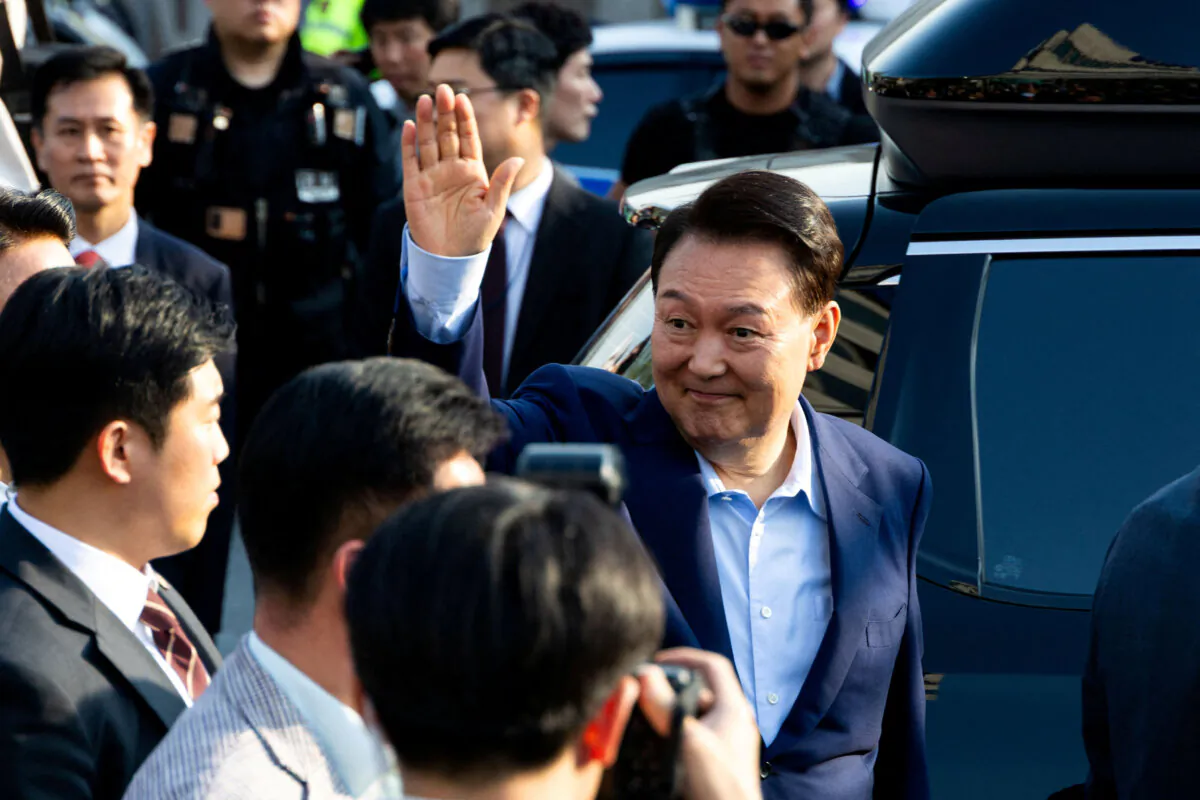 Ousted former South Korean President Yoon Suk Yeol waves to his supporters as he moves out of the presidential residence in Seoul, South Korea, on Apr. 11, 2025. (Yonhap/via Reuters)