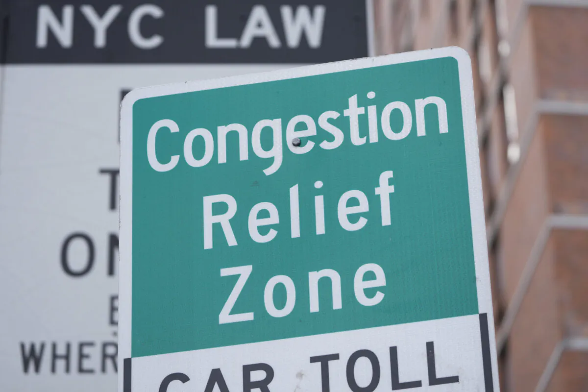 Signs advising drivers of congestion-pricing tolls are displayed near the Lincoln Tunnel in New York on Feb. 19, 2025. (Seth Wenig/AP Photo)