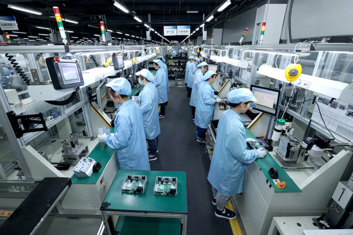 Workers work on a production line at a factory in Suqian, Jiangsu Province, China, on April 9, 2025. (China Daily via Reuters)