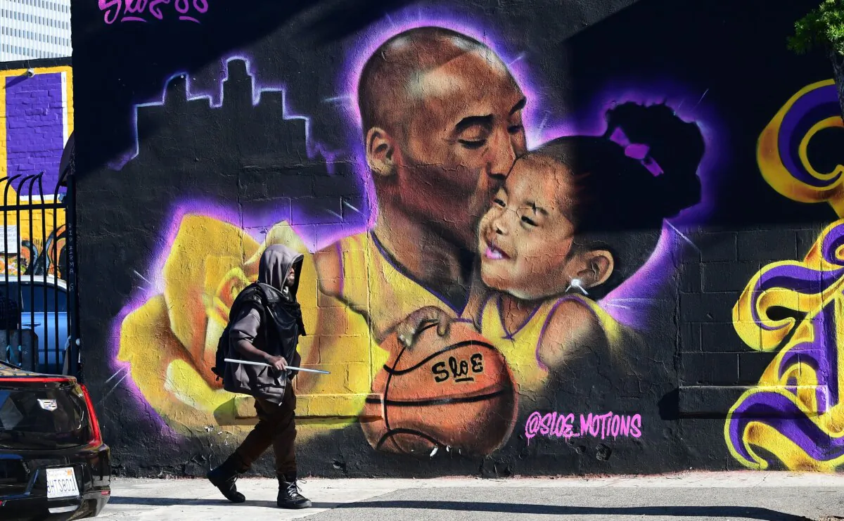 A pedestrian walks past a mural of the late Kobe Bryant and daughter Gianna by artist @sloe_motions in Los Angeles on January 25, 2022. (Frederic J. Brown/AFP via Getty Images)