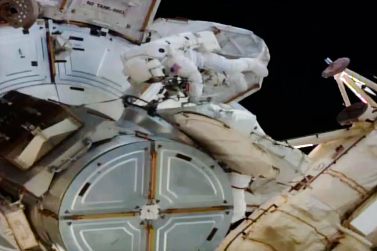 In this image provided by NASA, astronauts Anne McClain and Nichole Ayers work outside the International Space Station during a spacewalk, on May 1, 2025. (AP Photo/NASA TV)