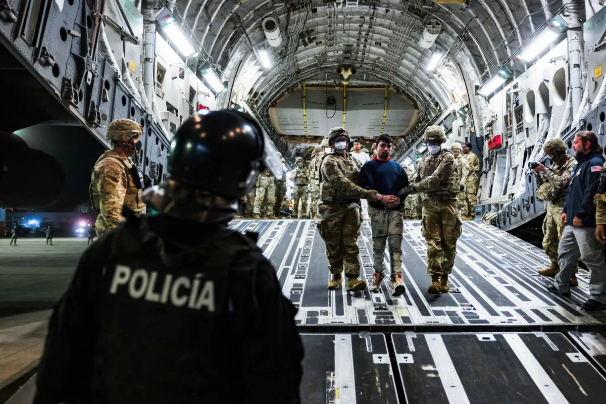 U.S. military personnel escort alleged members of the Venezuelan gang Tren de Aragua and the MS-13 gang recently deported by the U.S. government to be imprisoned in the Terrorism Confinement Center (CECOT) prison, at the El Salvador International Airport in San Luis Talpa, El Salvador, on April 12, 2025. (Secretaria de Prensa de la Presidencia/Handout via Reuters) 