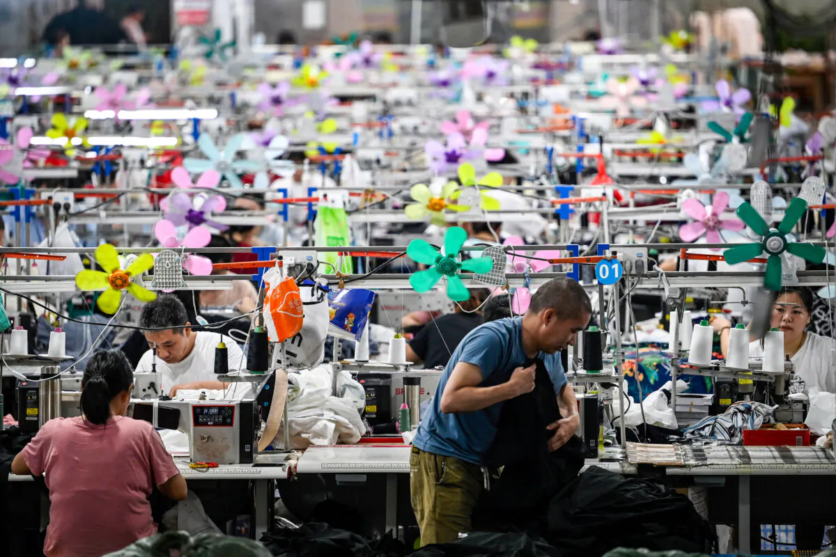 Workers produce garments at a textile factory supplying fast fashion e-commerce company Shein in Guangzhou, Guangdong Province, China, on June 11, 2024. In April, President Donald Trump signed an executive order ending de minimis duty-free exemptions for goods from China and Hong Kong, effective May 2. (Jade Gao/AFP via Getty Images)