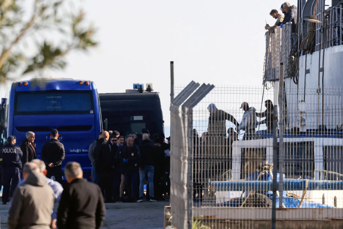 Illegal immigrants from various detention centers across Italy are escorted by police as they disembark an Italian Navy vessel at the port of Shengjin, Albania, on April 11, 2025. (Adnan Beci/AFP via Getty Images)