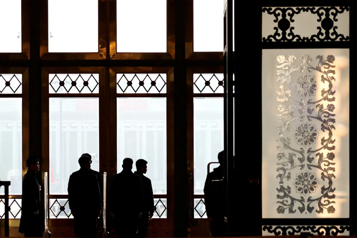 Security personnel keep watch at the second plenary session of China's rubber-stamp legislature, the National People's Congress, in Beijing on March 8, 2025. (Tingshu Wang/Reuters)