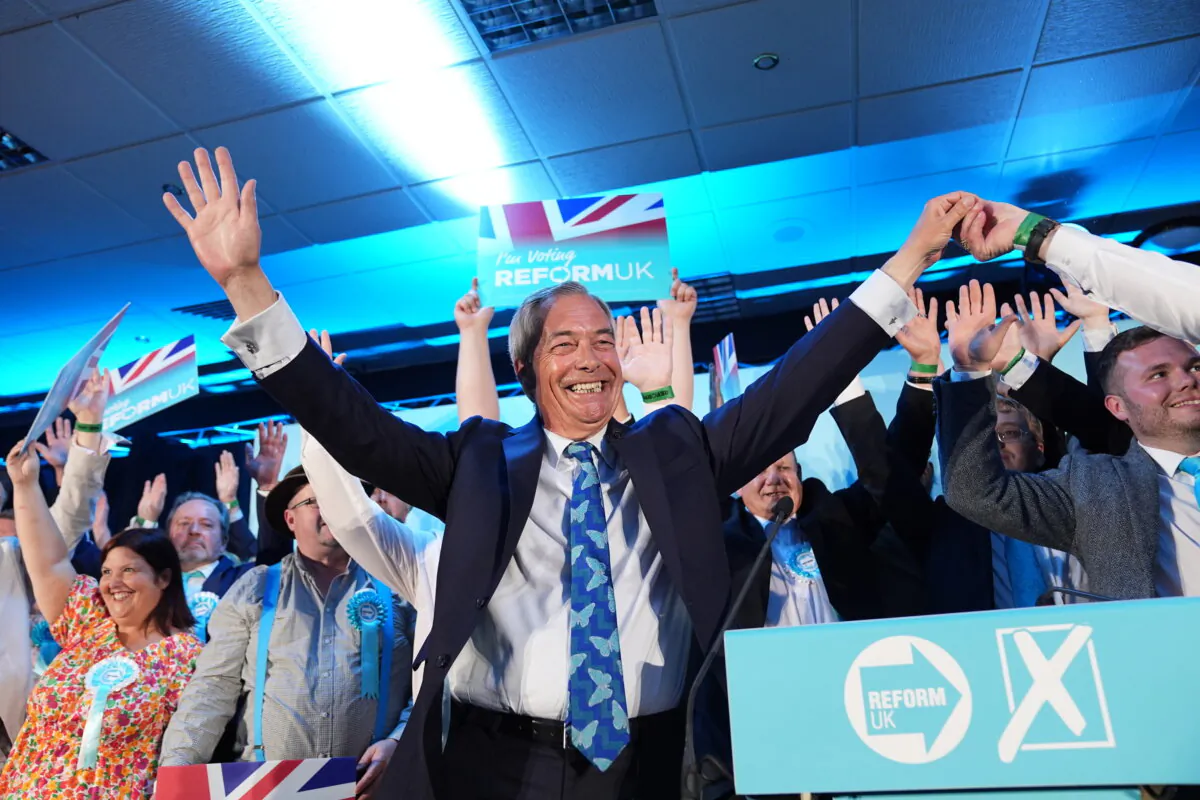 Reform UK party leader Nigel Farage with his party's candidates onstage during a campaign event at Stafford Showground, Stafford, whilst campaigning for this week's local elections on April 30, 2025. (Jacob King/PA)