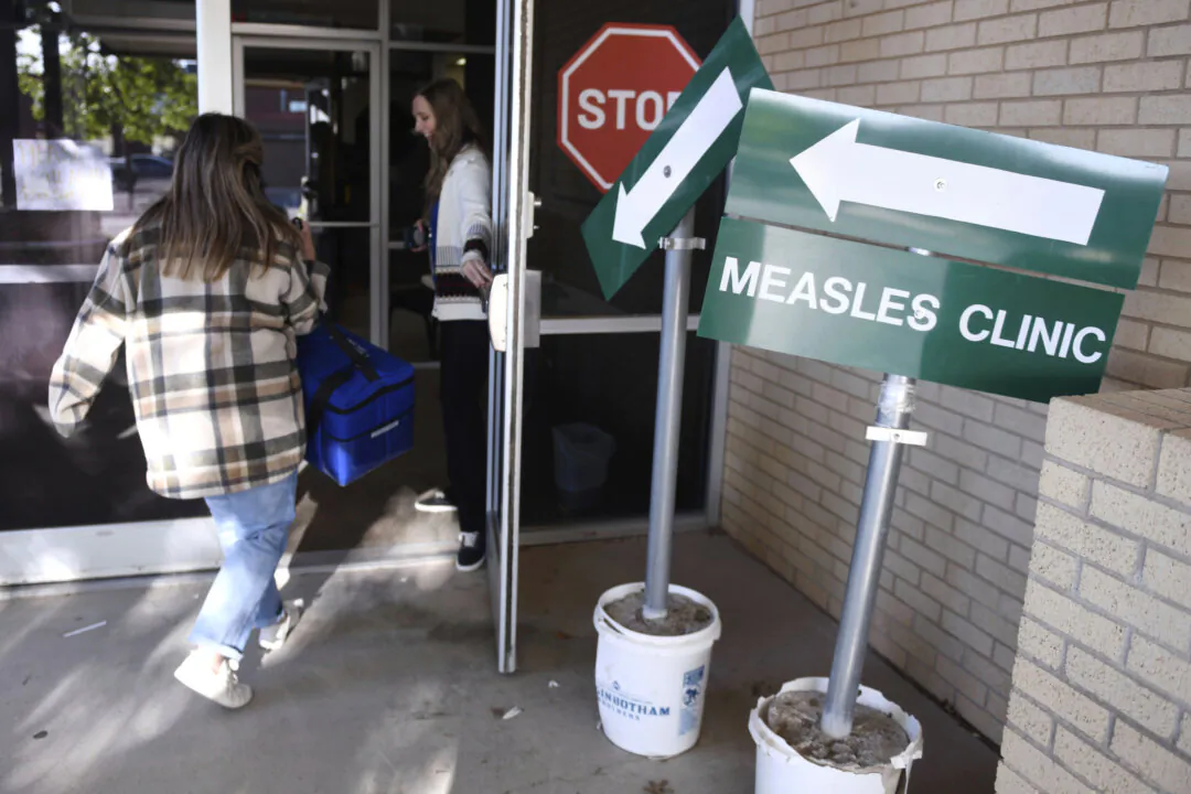 Health department staff members enter the Andrews County Health Department measles clinic in Andrews, Texas, on April 8, 2025. (Annie Rice/AP Photo)