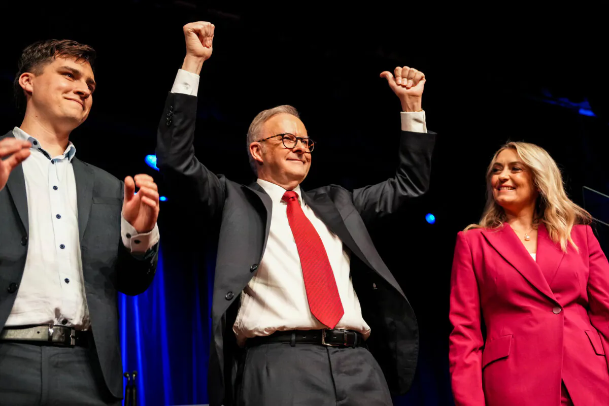 Australian Prime Minister Anthony Albanese raises his hands in victory with his fiancée, Jodie Haydon, and his son, Nathan Albanese, during the Labor Party’s election night event in Sydney, Australia on May 3, 2025. (Asanka Ratnayake/Getty Images)
