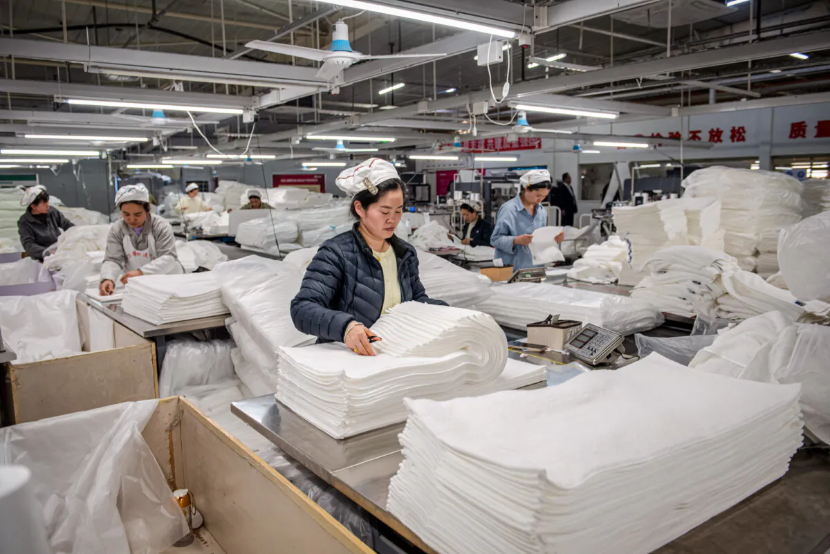 Employees work on a towel production line at a factory in Huaian, Jiangsu Province, China, on April 2, 2025. (-/AFP via Getty Images)