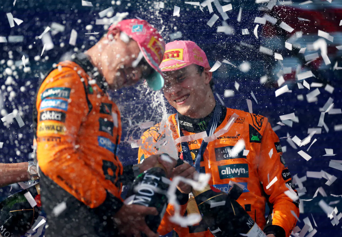 Lando Norris of Great Britain (L) and McLaren Race winner Oscar Piastri of Australia (C) celebrate on the podium during the F1 Grand Prix of Miami at Miami International Autodrome on May 4, 2025. (Reuters/Ricardo Arduengo)