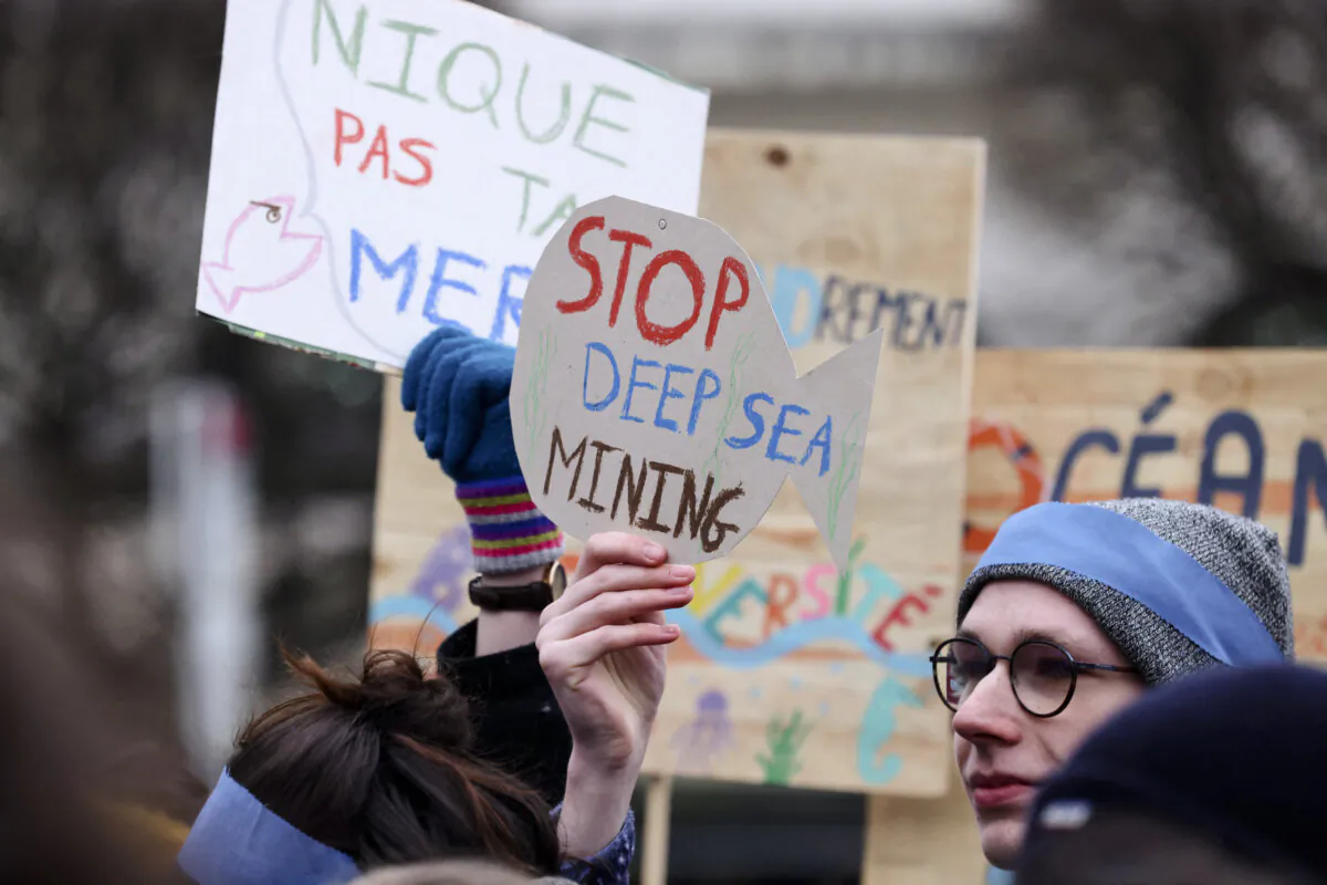 Activists take part at a "Look Down action" rally to stop deep-sea mining, outside the European Parliament in Brussels on March 6, 2023. (Kenzo Tribouillard/AFP via Getty Images)
