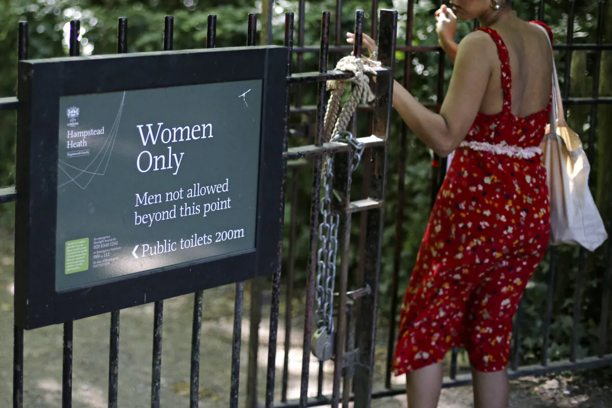 The sign indicating the 'Women Only' swimming pool is seen attached to gates on Hampstead Heath in central London on June 27, 2018. (Daniel Leal/AFP via Getty Images)