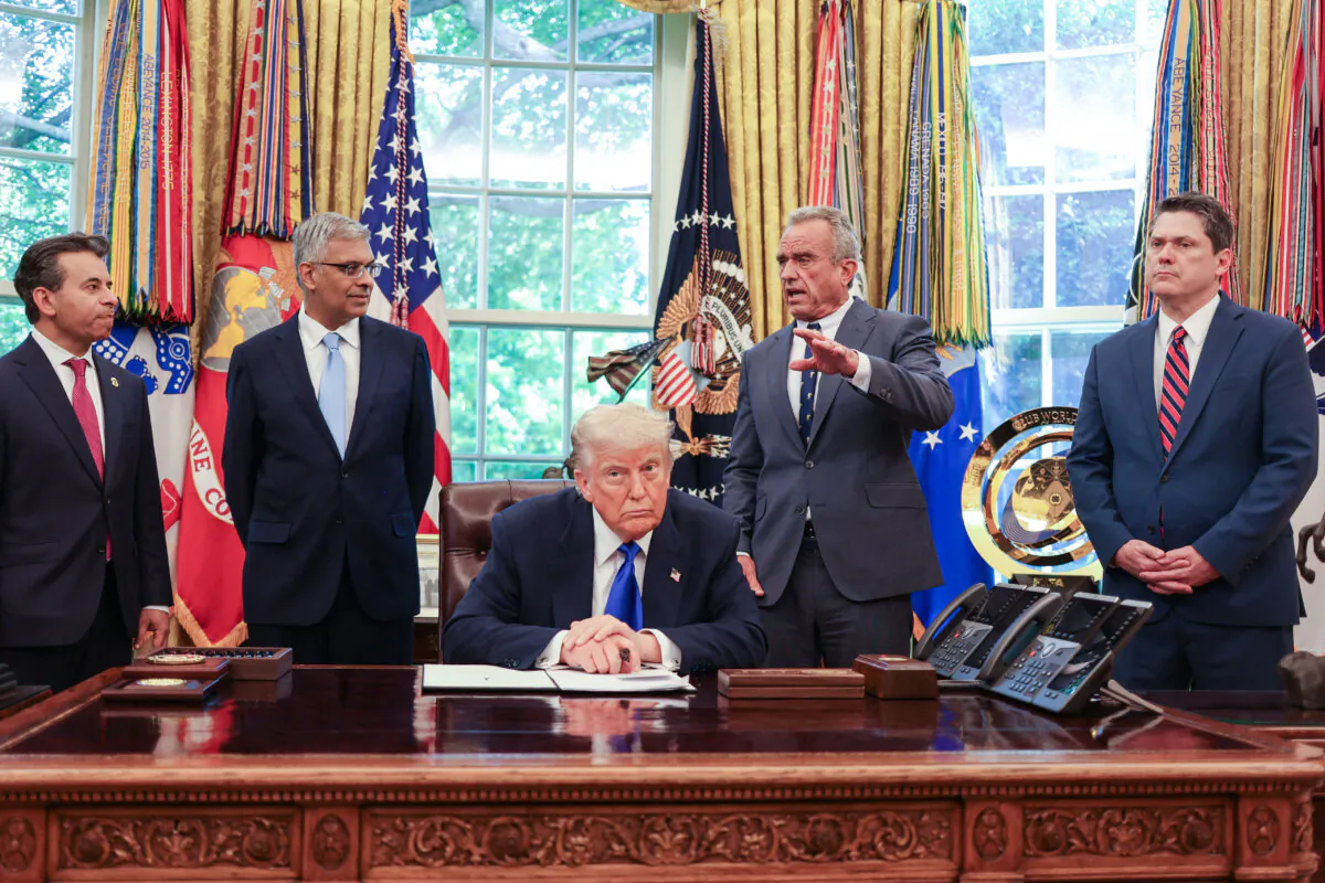 U.S. Secretary of Health and Human Services Robert F. Kennedy Jr. speaks alongside (L-R) Food and Drug Administration Commissioner Martin Makary, Director of the National Institutes of Health Jayanta Bhattacharya, President Donald Trump, and speechwriter and political advisor Vince Haley during an executive orders signing event in the Oval Office on May 5, 2025. (Alex Wroblewski/AFP via Getty Images)
