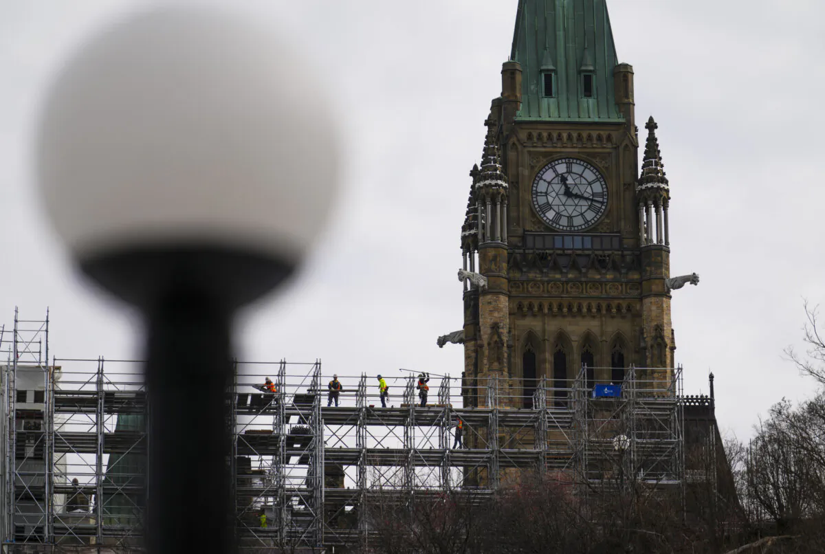 Construction workers build scaffolding on Parliament Hill in Ottawa on March 20, 2025. (The Canadian Press/Sean Kilpatrick)