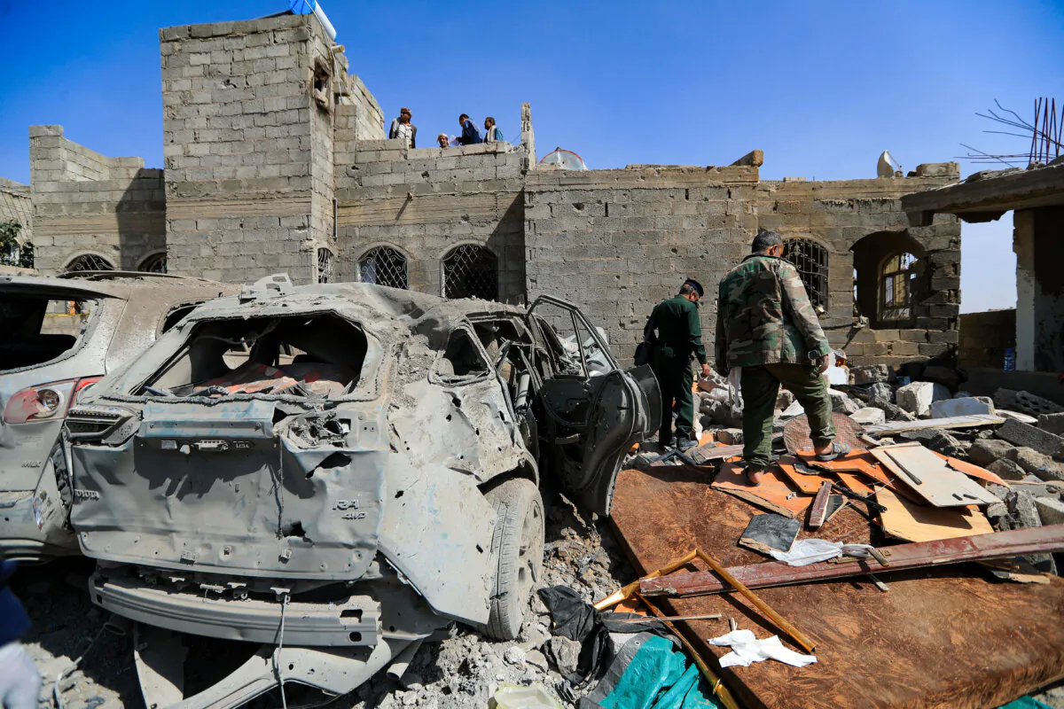 Houthi terrorists inspect the site of a reported U.S. airstrike in Sanaa, a day after the attack, on April 7, 2025. (Mohammed Huwais/AFP via Getty Images)