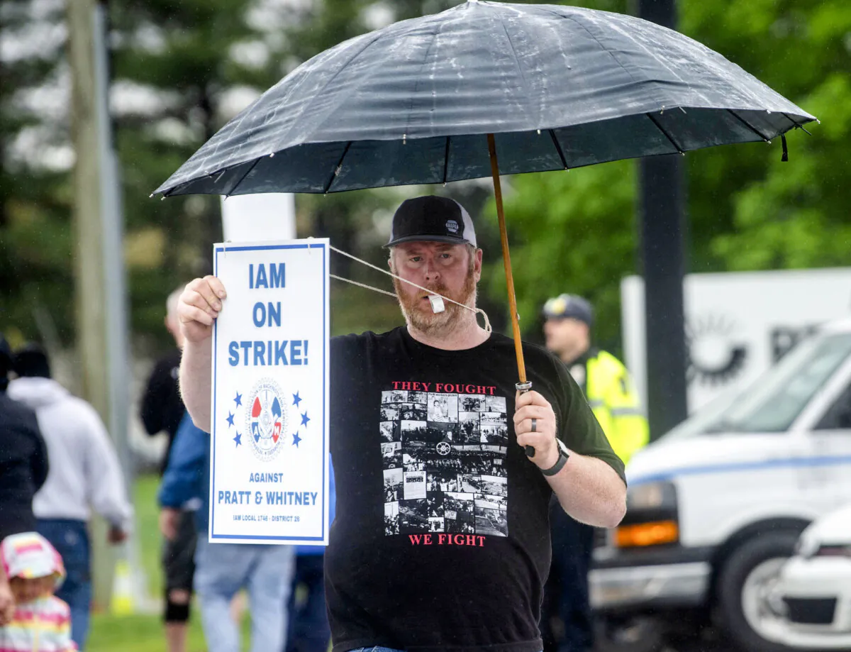 Andy Opgaard, a Pratt & Whitney employee, crosses the street to join fellow strikers on the picket line at the Silver Lane entrance on the first day of their strike, in East Hartford, Conn., on May 5, 2025. (Aaron Flaum/Hartford Courant via AP)