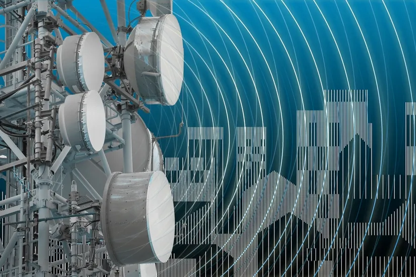 Concept with base radio station for global communications services and electromagnetic emissions fields against a cityscape. (Francesco Scatena/Shutterstock)