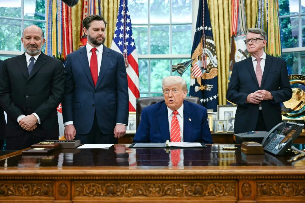 President Donald Trump makes a trade announcement as Secretary of Commerce Howard Lutnick (L), Vice President JD Vance (2nd L), and British ambassador to the United States Peter Mandelson (R), look on in the Oval Office of the White House on May 8, 2025. (Jim Watson/AFP via Getty Images)