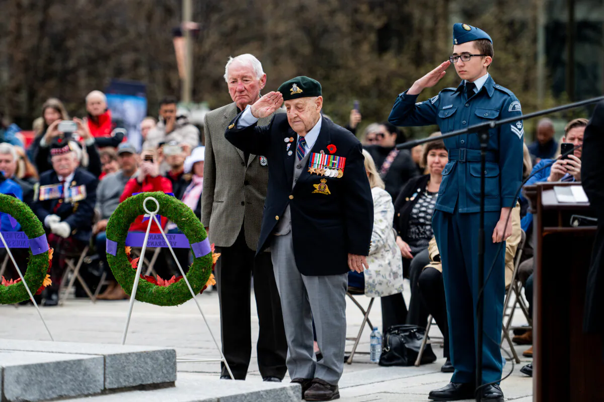 Second World War veteran Roland Lalonde (C) salutes after placing a wreath with fellow Second World War veteran Roy Martel during a ceremony marking the 80th anniversary of the Liberation of the Netherlands and Victory in Europe Day at the National War Memorial in Ottawa on May 8, 2025. (The Canadian Press/Spencer Colby)