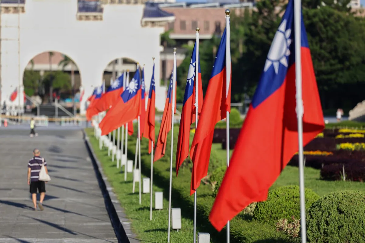 A man walks past Taiwanese flags on Democracy Boulevard at Chiang Kai-shek Memorial Hall in Taipei, Taiwan, on Oct. 15, 2024. (I-Hwa Cheng/AFP via Getty Images)
