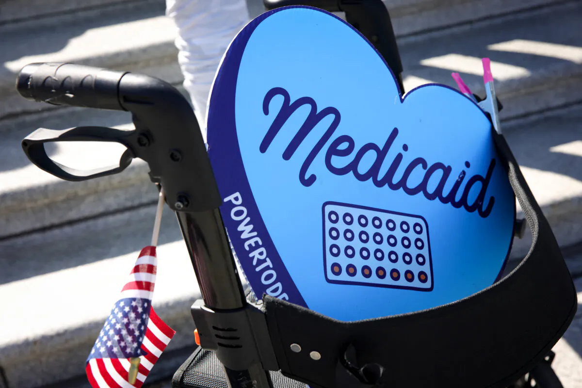 A sign in support of Medicaid rests in a walking device in Washington on April 27, 2025. (Bryan Dozier/Middle East Images/AFP via Getty Images)