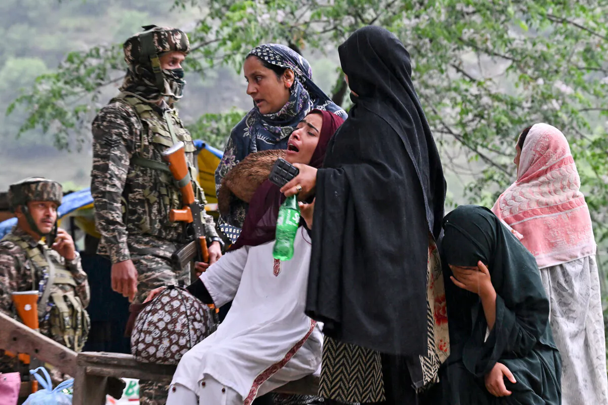 Indian villagers wait for transportation as they evacuate following overnight Pakistani artillery shelling in Uri, near the Line of Control with Pakistan, on May 9, 2025. (Tauseef Mustafa/AFP via Getty Images)
