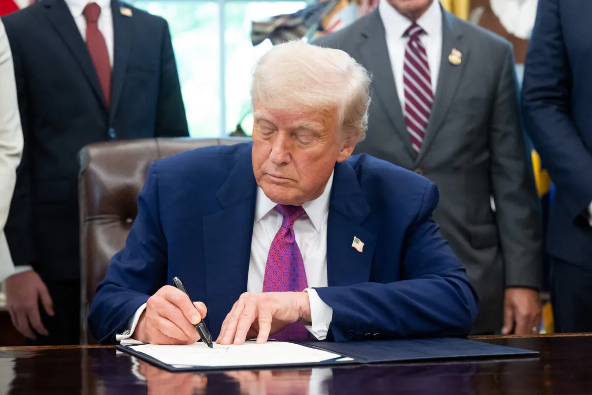 President Donald Trump signs legislation in the Oval Office of the White House in Washington on May 9, 2025. (Saul Loeb/AFP via Getty Images)