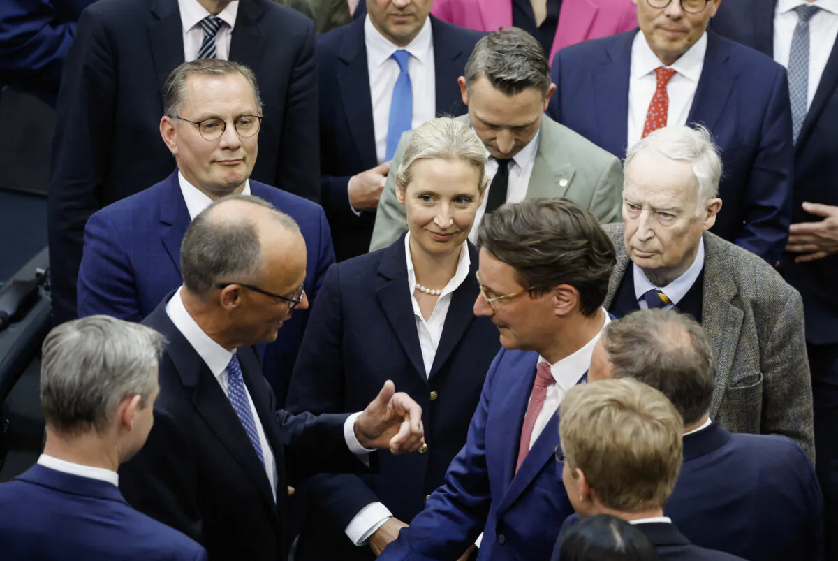 German Chancellor Friedrich Merz is congratulated by CDU MP Hendrik Wust under the eyes of the co-leaders of the AfD party Tino Chrupalla (back L) and Alice Weidel (C) and honorary AfD chairman Alexander Gauland (R), in Berlin, dated May 6, 2025. (Odd Andersen/AFP via Getty Images)